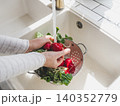 Hands washing fresh radishes 140352779
