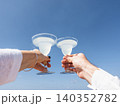 Two hands holding glasses of drink 140352782