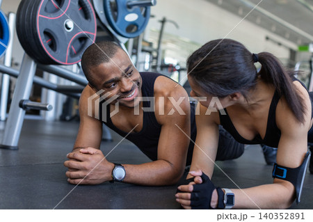 Young black fitness resting in forearm plank position and smiling 140352891