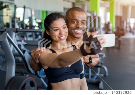 Young black taking selfie together in gym after exercise Young black taking selfie together in gym after exercise 140352926