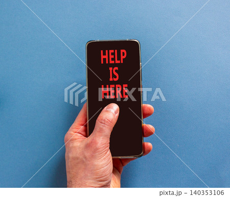 Help is here and support words symbol. Concept words Help is here on beautiful black phone screen. Beautiful blue background. Businessman hand. Business help is here and support concept. Copy space. 140353106