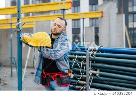 Construction worker wearing hard hat and safety glasses Construction worker wearing hard hat and safety glasses 140353204