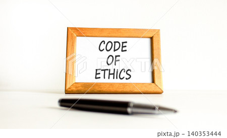 Code of ethics words symbol. Concept words Code of ethics on beautiful wooden picture frame. Beautiful white background. Business Code of ethics concept. Copy space. Code of ethics words symbol. Concept words Code of ethics on beautiful wooden picture frame. Beautiful white background. Business Code of ethics concept. Copy space. 140353444