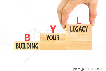 BYL building your legacy symbol. Concept words BYL building your legacy on beautiful wooden blocks. Beautiful white background. Businessman hand. Business BYL building your legacy concept. Copy space. BYL building your legacy symbol. Concept words BYL building your legacy on beautiful wooden blocks. Beautiful white background. Businessman hand. Business BYL building your legacy concept. Copy space. 140353509
