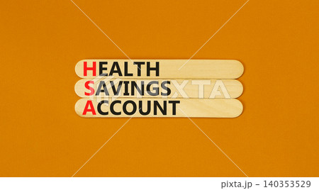HSA health saving account symbol. Concept words HSA health saving account on beautiful wooden sticks. Beautiful orange background. Medical HSA health saving account concept. Copy space. 140353529