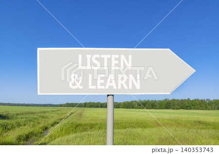 Listen and learn words symbol. Concept words Listen and learn on beautiful grey road sign. Beautiful blue sky green field background. Business listen and learn support concept. Copy space. 140353743