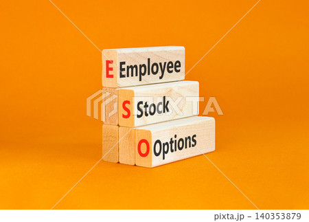 ESO employee stock options symbol. Concept words ESO employee stock options on beautiful wooden blocks. Beautiful orange background. Business ESO employee stock options concept. Copy space. 140353879
