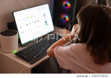 Person working on a computer at home in the afternoon Person working on a computer at home in the afternoon 140353932