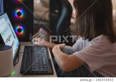 Person working on a computer in a home office setting Person working on a computer in a home office setting 140353933