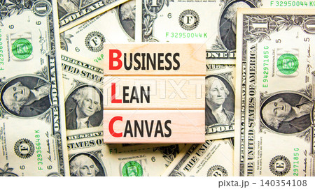 BLC business lean canvas symbol. Concept words BLC business lean canvas on beautiful wooden blocks. Beautiful dollar bills background. Dollar bills. BLC business lean canvas concept. Copy space. 140354108