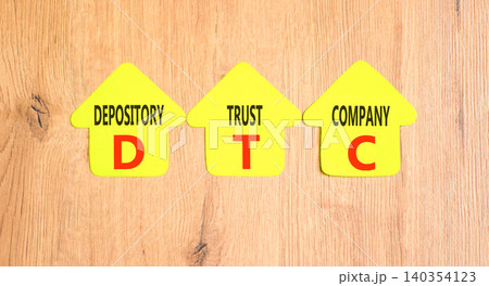 DTC depository trust company symbol. Concept words DTC depository trust company on beautiful yellow paper houses. Beautiful wooden background. Business DTC depository trust company concept. Copy space DTC depository trust company symbol. Concept words DTC depository trust company on beautiful yellow paper houses. Beautiful wooden background. Business DTC depository trust company concept. Copy space 140354123
