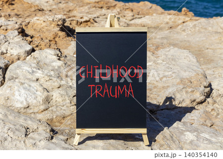 Childhood trauma words symbol. Concept words Childhood trauma on beautiful black blackboard. Beautiful stone background. Psychological childhood trauma support concept. Copy space. Childhood trauma words symbol. Concept words Childhood trauma on beautiful black blackboard. Beautiful stone background. Psychological childhood trauma support concept. Copy space. 140354140