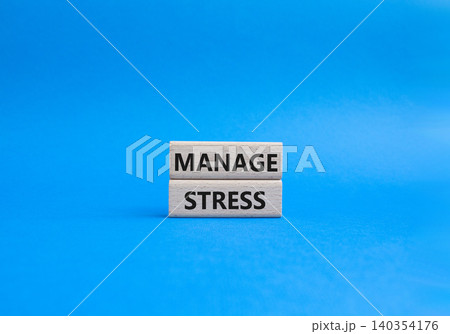 Manage stress symbol. Concept word Manage stress on wooden blocks. Beautiful blue background. Business and Manage stress concept. Copy space 140354176
