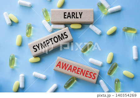 Early symptoms awareness symbol. Concept words Early symptoms awareness on wooden blocks. Beautiful blue background with pills. Healthcare and Early symptoms awareness concept. Copy space. Early symptoms awareness symbol. Concept words Early symptoms awareness on wooden blocks. Beautiful blue background with pills. Healthcare and Early symptoms awareness concept. Copy space. 140354269