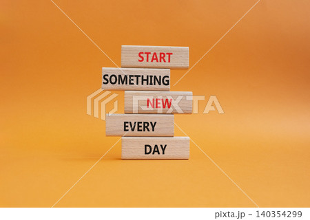 New symbol. Wooden blocks with words Start Something New Every Day. Beautiful orange background. Business and New concept. Copy space 140354299