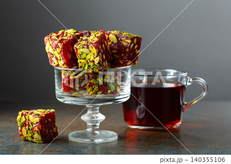 Turkish delights with black tea on a dark  background. 140355106