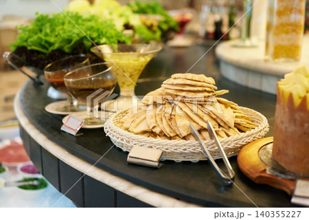 Food, platter and bread in restaurant buffet for catering service, selection and banquet for eating. Cafeteria, fine dining and closeup of snack table for lunch, supper and dinner event for health Food, platter and bread in restaurant buffet for catering service, selection and banquet for eating. Cafeteria, fine dining and closeup of snack table for lunch, supper and dinner event for health 140355227
