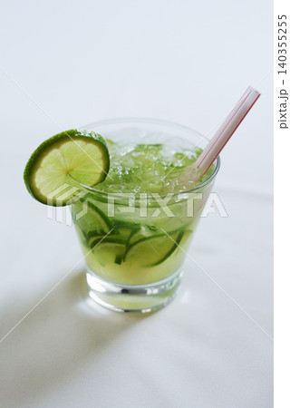 Cocktail, alcohol and glass with lime for mojito drink on table for party, club and bar. Mockup, background and closeup of mocktail, beverage and liquid with fruit, ice and liquor for celebration Cocktail, alcohol and glass with lime for mojito drink on table for party, club and bar. Mockup, background and closeup of mocktail, beverage and liquid with fruit, ice and liquor for celebration 140355255