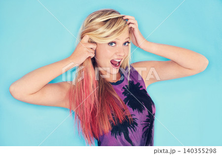 Woman, attitude portrait and punk fashion in studio mock up and surprise emoji in rock style. California, girl and face of celebrating in trendy clothes and pink hair for gen z by blue background Woman, attitude portrait and punk fashion in studio mock up and surprise emoji in rock style. California, girl and face of celebrating in trendy clothes and pink hair for gen z by blue background 140355298