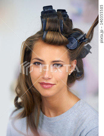 Woman, face and smile with hair curlers for beauty, haircare and hairstyle with makeup or cosmetics at hairdresser. Person, happy and roller set for grooming, curling and getting ready with skincare Woman, face and smile with hair curlers for beauty, haircare and hairstyle with makeup or cosmetics at hairdresser. Person, happy and roller set for grooming, curling and getting ready with skincare 140355585