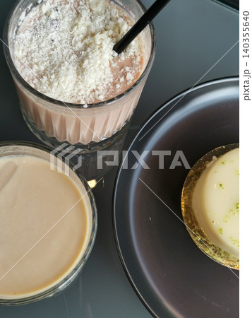 Top view of two ice-coffee with desert in cafe. Vertical photo Top view of two ice-coffee with desert in cafe. Vertical photo 140355640