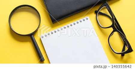 Business concept with notebook magnifier and black glasses 140355642