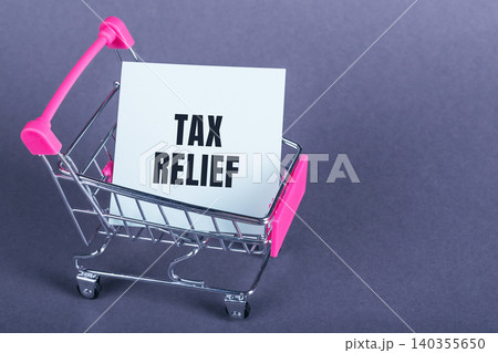 Small Pink Shopping Cart With White Card Displaying Tax Relief Small Pink Shopping Cart With White Card Displaying Tax Relief 140355650
