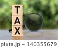 The word TEX on wooden cubes on a table with a magnifying glass. 140355679