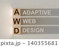 Wooden cubes with the word AWD - Adaptive Web Design, with a falling shadow on a gray background. 140355681