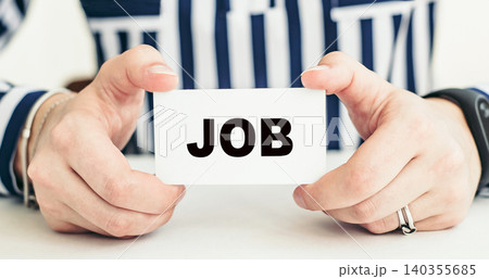 JOB. Woman holding a card with a message text written on it. 140355685