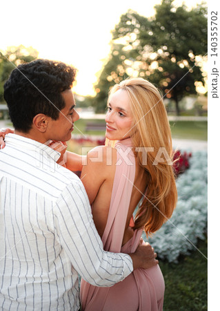 Couple enjoying a romantic moment during golden hour in the park 140355702