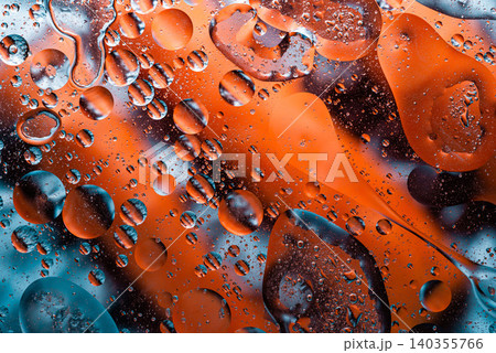 Dynamic pattern of orange oil drops in water mixture Dynamic pattern of orange oil drops in water mixture 140355766