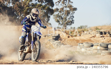 Motorcycle, person and speed with dust cloud for games, contest or challenge in action for extreme sports. Racer, motorbike and dirt on path, road and trail in nature with fast transport in summer 140355796