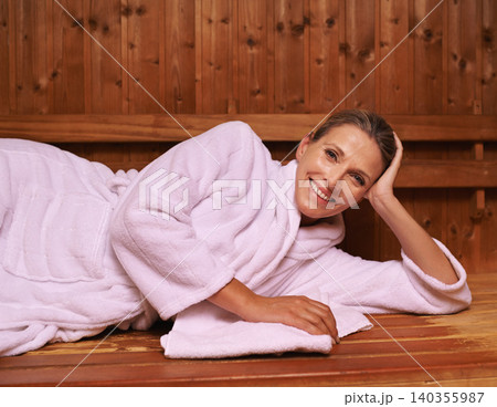 Woman, portrait and relax in sauna or treatment for spa vacation or wellness care for resting, detox or holiday. Female person, face and bathrobe or peace at Bali resort or rest, stress free or calm 140355987