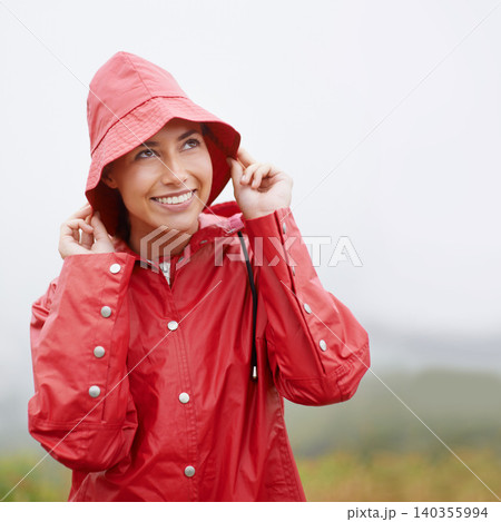 Woman, smile and raincoat for protection, outdoor nature and waterproof jacket for rain or weather. Female person, happy and safety or shield from cold, winter and travel to Scotland for holiday Woman, smile and raincoat for protection, outdoor nature and waterproof jacket for rain or weather. Female person, happy and safety or shield from cold, winter and travel to Scotland for holiday 140355994