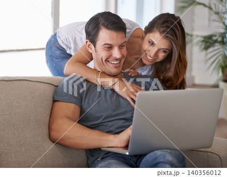 Laptop, smile and woman hugging man on sofa networking on social media, website or internet. Happy, love and female person embracing husband reading online blog with computer in living room at home. Laptop, smile and woman hugging man on sofa networking on social media, website or internet. Happy, love and female person embracing husband reading online blog with computer in living room at home. 140356012