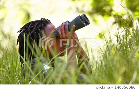 Nature, binoculars and kid in grass for exploring in park on vacation, adventure or holiday. Travel, forest and young boy child with equipment in lawn in outdoor field or woods on weekend trip. Nature, binoculars and kid in grass for exploring in park on vacation, adventure or holiday. Travel, forest and young boy child with equipment in lawn in outdoor field or woods on weekend trip. 140356060