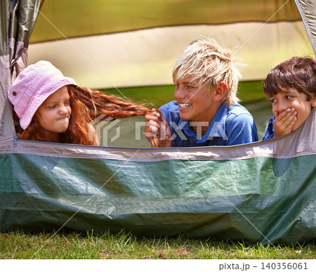 Kids, camp and outdoors for tent, friends and nature on summer vacation with boys pulling person hair. Children, annoyed girl and holiday for adventure, tease and camping in backyard and on grass Kids, camp and outdoors for tent, friends and nature on summer vacation with boys pulling person hair. Children, annoyed girl and holiday for adventure, tease and camping in backyard and on grass 140356061