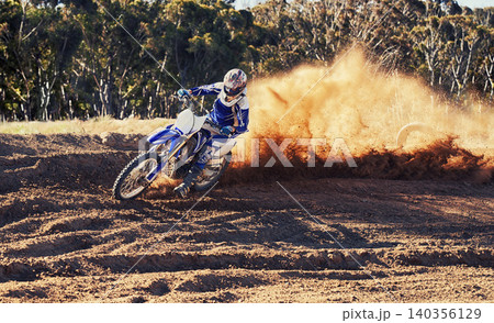 Person, dirt bike and professional motorcyclist racing in extreme sports or competition on outdoor track. Expert rider on motorbike or scrambler for sand course, challenge or off road rally in nature Person, dirt bike and professional motorcyclist racing in extreme sports or competition on outdoor track. Expert rider on motorbike or scrambler for sand course, challenge or off road rally in nature 140356129