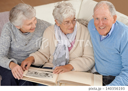 Old people, friends and photo album for memory nostalgia in retirement on sofa together, photograph or connection. Elderly man, women and picture book in home in Canada for bonding, remember or love Old people, friends and photo album for memory nostalgia in retirement on sofa together, photograph or connection. Elderly man, women and picture book in home in Canada for bonding, remember or love 140356193
