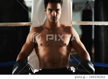 Portrait, man and boxing ring for sports, training and workout at corner of gym for body health. Fighter, serious face and athlete with gloves for fitness, exercise or strong abs at club in Brazil 140356362
