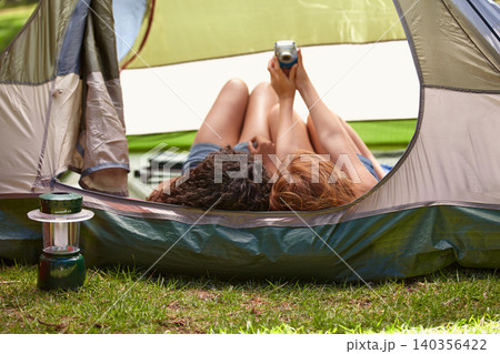 Camping, selfie and friends in tent with camera for memory of vacation and relax together. Back, head and girls capture photography with tech on holiday, adventure or casual moment outdoor in summer 140356422