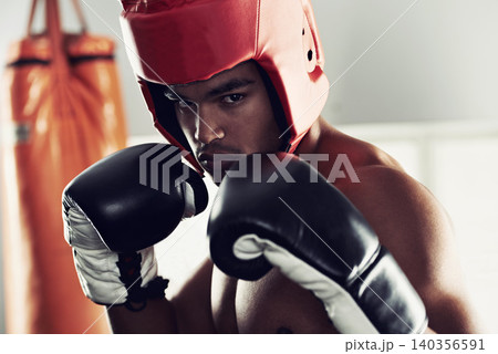 Sports, portrait and man boxer in gym for exercise, workout and combat training for competition. Breathing, health and shirtless male athlete fighter in boxing ring with gloves in fitness center. 140356591