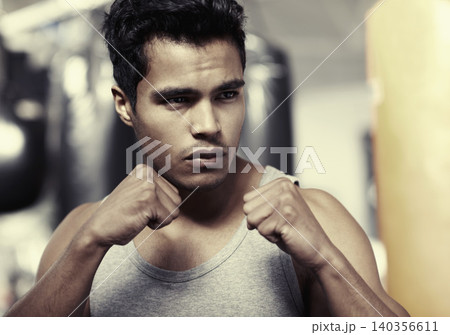 Man, boxer and training at gym fitness for health, wellness and professional in posture. Strong male trainer, workout and building strength with energy competition, mma and active in sports exercise Man, boxer and training at gym fitness for health, wellness and professional in posture. Strong male trainer, workout and building strength with energy competition, mma and active in sports exercise 140356611