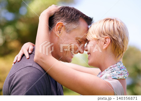 Love, hug and couple in nature with romance, support and trust, bonding and sharing sweet moment outdoor together. Safety, smile or happy people embrace in a forest for summer date, solidarity or fun Love, hug and couple in nature with romance, support and trust, bonding and sharing sweet moment outdoor together. Safety, smile or happy people embrace in a forest for summer date, solidarity or fun 140356871