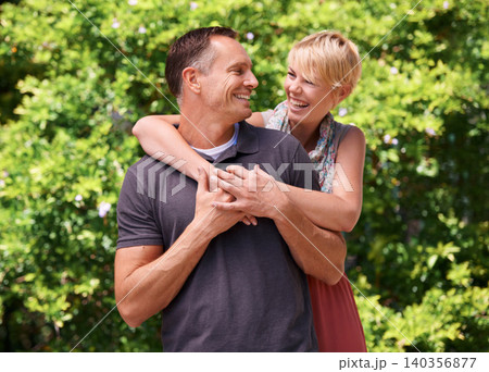 Love, hug and couple laughing in a park for travel, adventure and bonding in nature together. Smile, romance and people embrace in forest for summer date, reunion or weekend, holiday or support fun Love, hug and couple laughing in a park for travel, adventure and bonding in nature together. Smile, romance and people embrace in forest for summer date, reunion or weekend, holiday or support fun 140356877