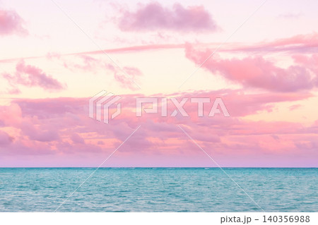 Tropical sunset with pink cloudy sky and peaceful water. 140356988
