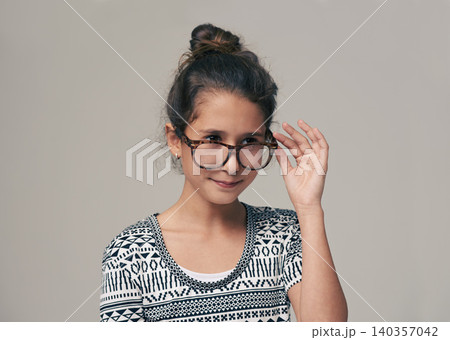 Kids, vision and glasses with happy girl child in studio isolated on gray background for optometry. Children, frame and eyewear with young female kid at eye clinic for prescription eyesight test Kids, vision and glasses with happy girl child in studio isolated on gray background for optometry. Children, frame and eyewear with young female kid at eye clinic for prescription eyesight test 140357042