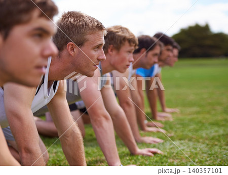 Group, men and field for push up with fitness, training and health with friends for sport, challenge or wellness. People, athlete and teamwork with exercise, workout and together on field for muscle 140357101