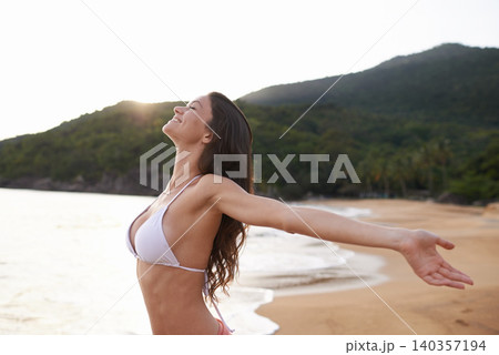 Outdoor, hands up or happy woman at sea for travel adventure to relax on holiday vacation. Bikini, peace or female person at beach with open arms in nature for fresh air, freedom or gratitude in Bali Outdoor, hands up or happy woman at sea for travel adventure to relax on holiday vacation. Bikini, peace or female person at beach with open arms in nature for fresh air, freedom or gratitude in Bali 140357194